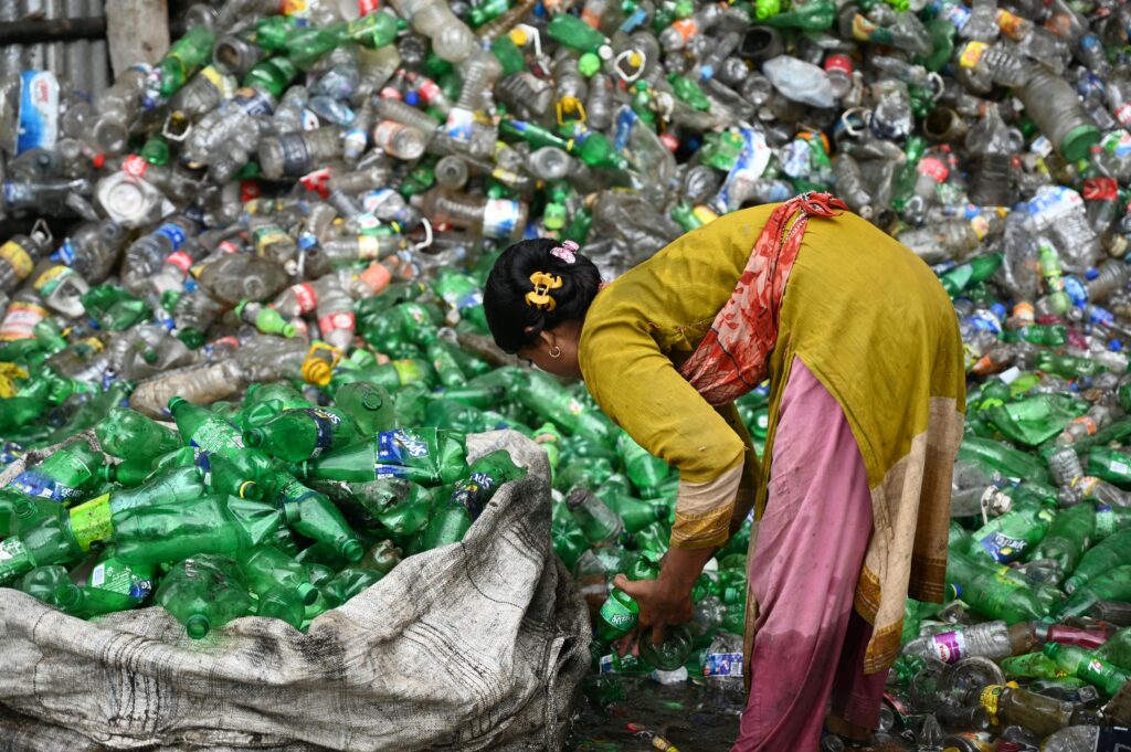 pexels-photo-5269922-5269922 Woman collecting and sorting plastic bottles for recycling in Chattogram, Bangladesh.